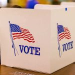 Biden Judge NUKES Noncitizen Voting Ban — Now Look At The TIMING voting booth with American flag graphics