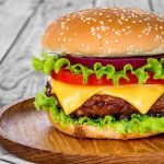 RECALL: 4.4 Million Grill Brushes. A Wire Can HIDE In Your Burger Cheeseburger with lettuce, tomato, and onion on a wooden plate