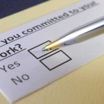 Pen hovering over yes no checkbox on questionnaire
