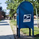 ALERT: Latest Mail Scare Just Got BIGGER — See Who ELSE Was Targeted Blue USPS mailbox on a suburban sidewalk