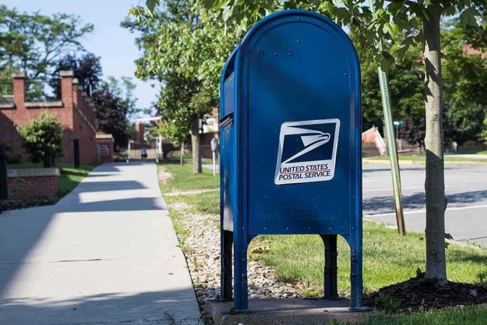 shutterstock_1123464173-1 Blue USPS mailbox on a suburban sidewalk
