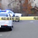 She Was Out On PROBATION — Now A 7-Year-Old Girl Is DEAD Police tape cordons off a street with patrol cars and flashing lights in the background