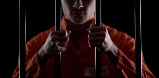 NOTORIOUS Killer FINALLY Nailed Prisoner in orange jumpsuit gripping jail bars