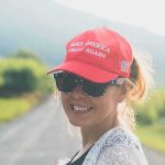 Trump’s New Pick Was Told To Lose Her MAGA Hat — Her ANSWER woman in red cap and sunglasses smiling outdoors