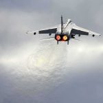 fighter jet taking off with afterburners glowing