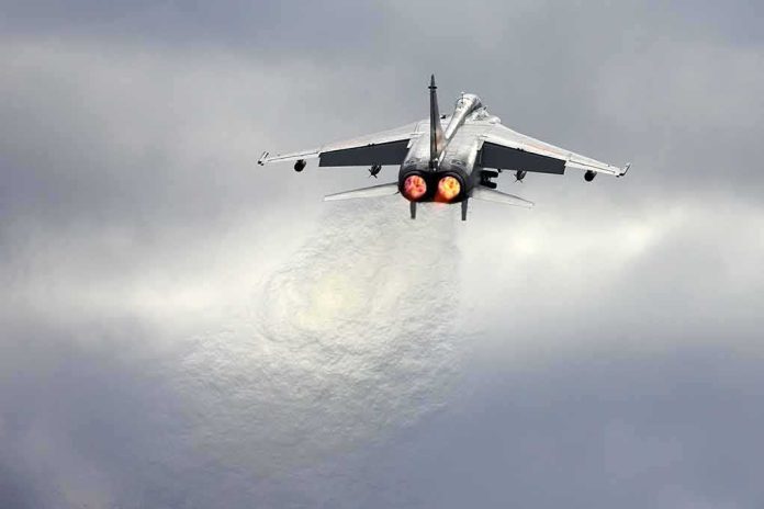 shutterstock_1705684678 fighter jet taking off with afterburners glowing