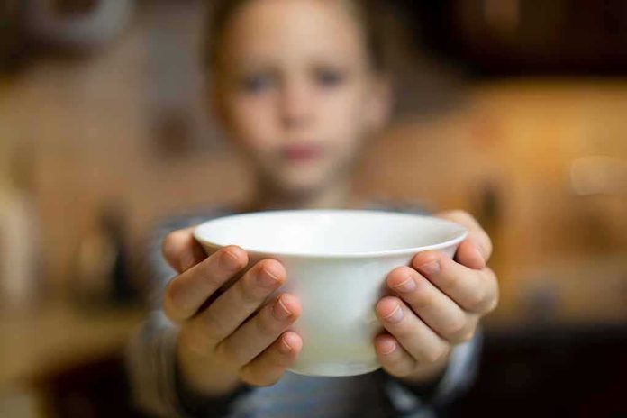 shutterstock_1709361340 Child holding a white bowl toward the camera