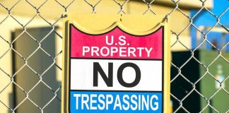 No trespassing sign on chain-link fence