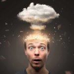 Surprised man with cloud explosion above head