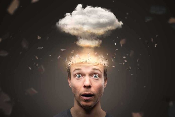 Surprised man with cloud explosion above head