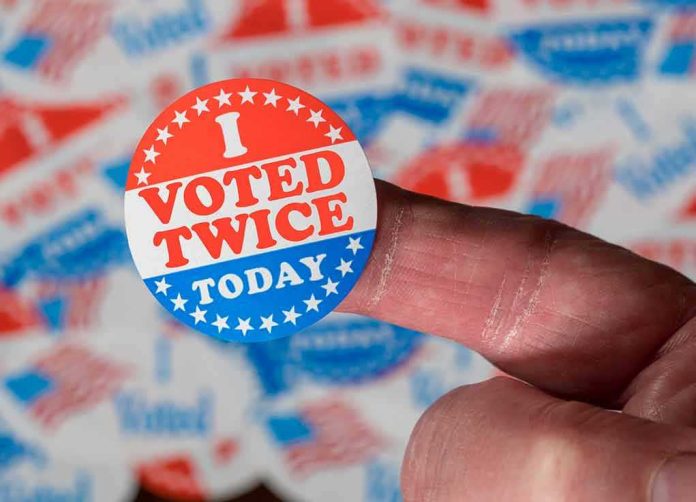 Hand holding a red, white, and blue voting sticker