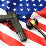 Gun Rights Gone For LIFE Over A DUI? Look Who Said YES Handgun and judge’s gavel on American flag