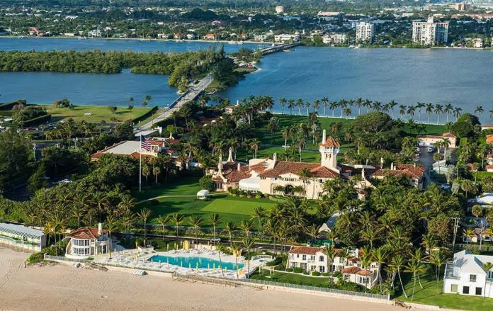 shutterstock_518463952-1 Aerial view of a waterfront estate with pool, lawns, and palm trees