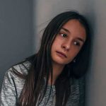 Girl Begs Supreme Court — Her School’s Excuse Is GUTLESS Teen girl leaning against a wall with a pensive expression