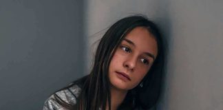 Girl Begs Supreme Court — Her School’s Excuse Is GUTLESS Teen girl leaning against a wall with a pensive expression
